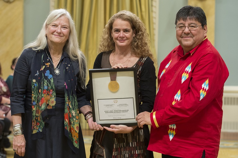 Julie Payette, Governor General of Canada, holds a framed certificate