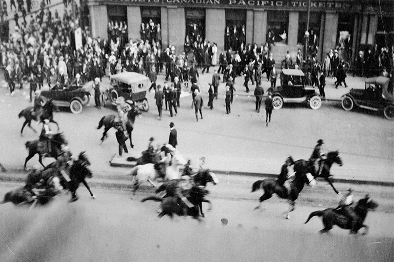 Men on horses and the horses are running to the right.